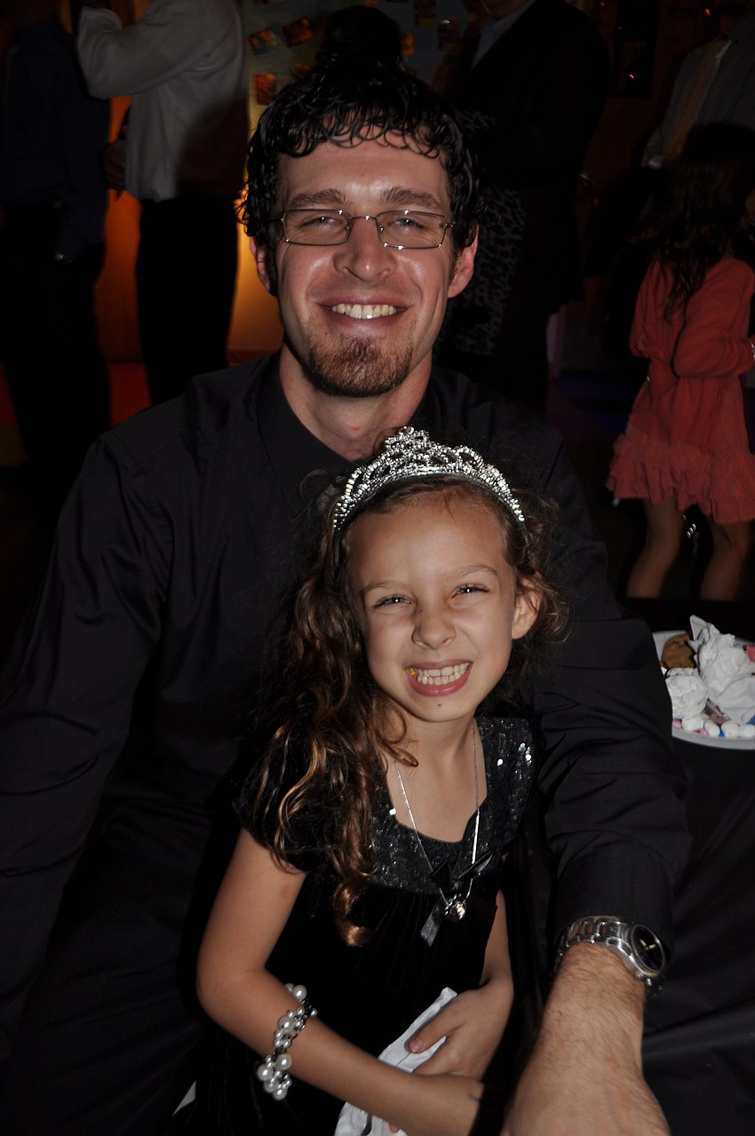 Chris and Addyson Mayo eat snacks.