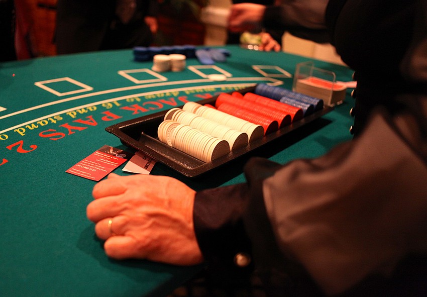 A dealer organizes the chips before her table fills up.