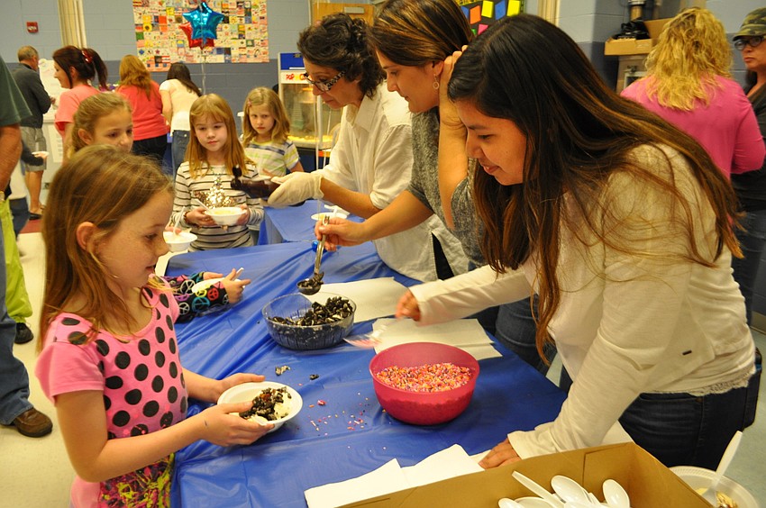 Layla Bennett, 2, is all smiles as she digs into her ice cream.