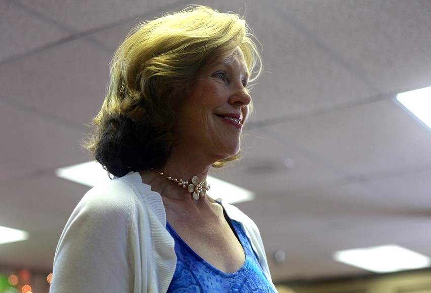 Alice Dzenitis smiles before walking down the runway.