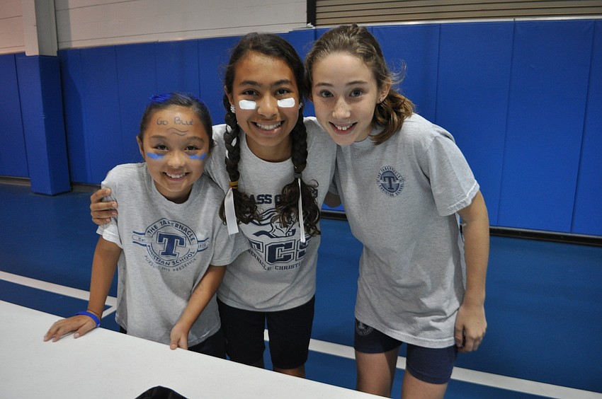 Sophia Franzone, Christiana Bedros and Jordan Flick cheer on competitors as they stack cups.