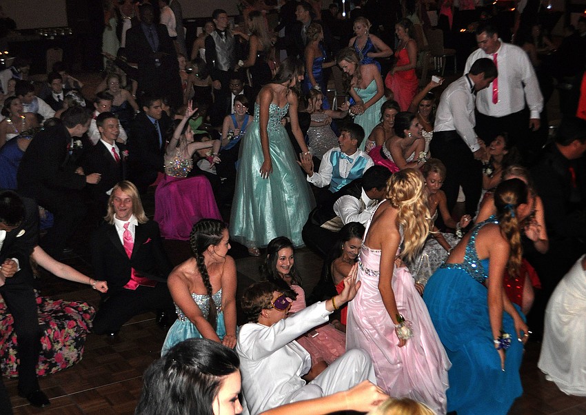 Students have fun on the dance floor early dancing to â€œCha Cha Slideâ€.