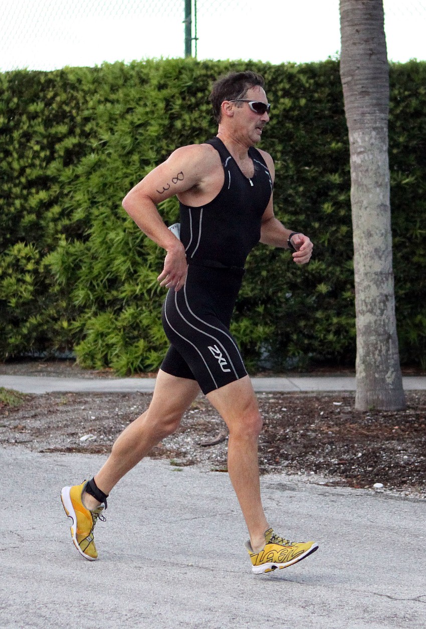 Stephen Habryl, No. 83, starts running for the final leg of the sprint triathlon.