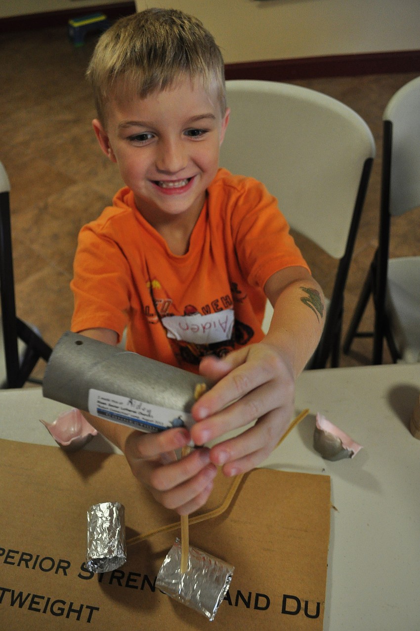 Aiden Lanham 6, makes a robot.