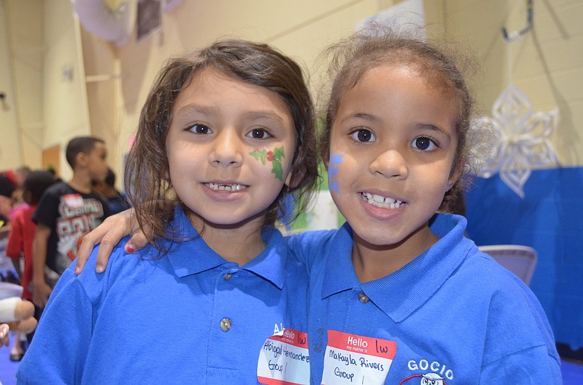 MaKayla Rivers and Abigail Hernandez wait in line to see Santa.