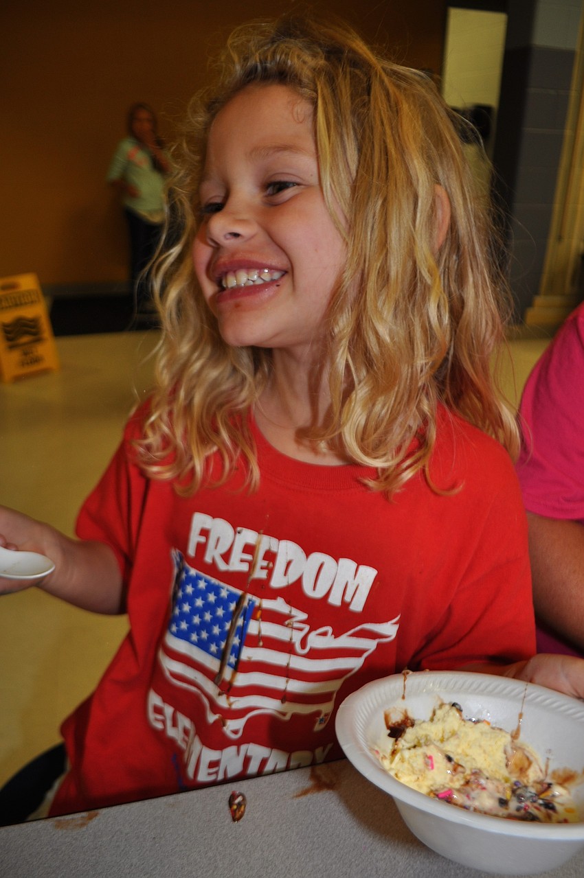 Madison Lefevre, 7, drips syrup down her shirt.