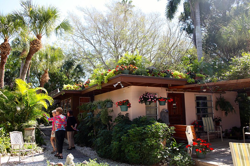 Jane Boehme shows guests around the garden.