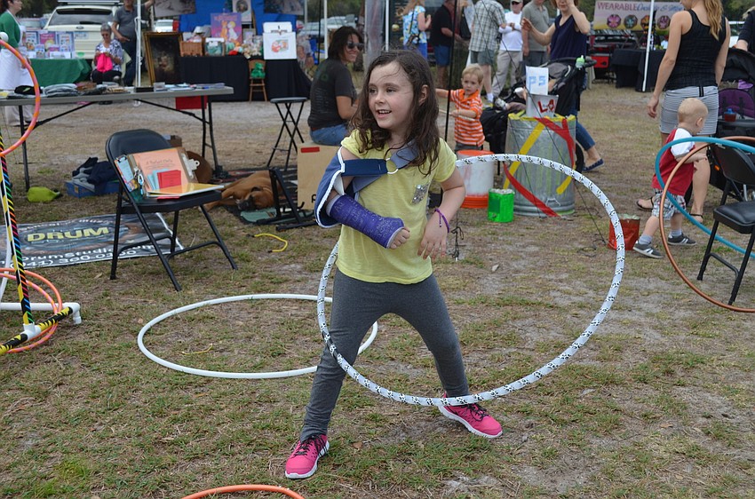 Maya Riel hula hoops with a broken arm.