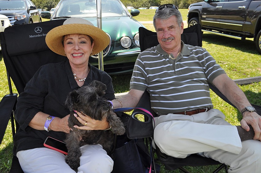 Linda and Richard Bradway hold their rescued schnauzer, Baby.