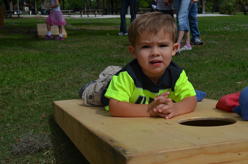 Mason Struble takes a break from playing corn hole.