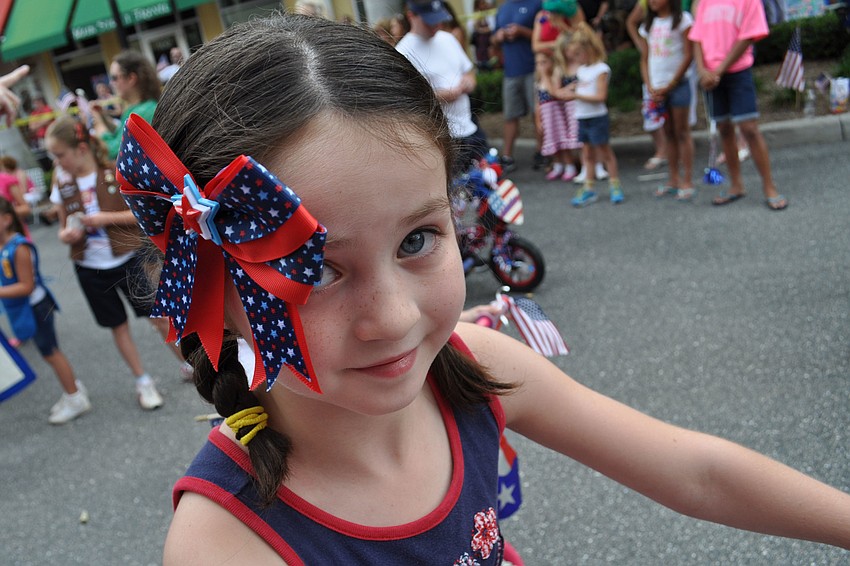 Hannah Hardin, 7, dressed in red, white and blue to match her decorated bicycle.