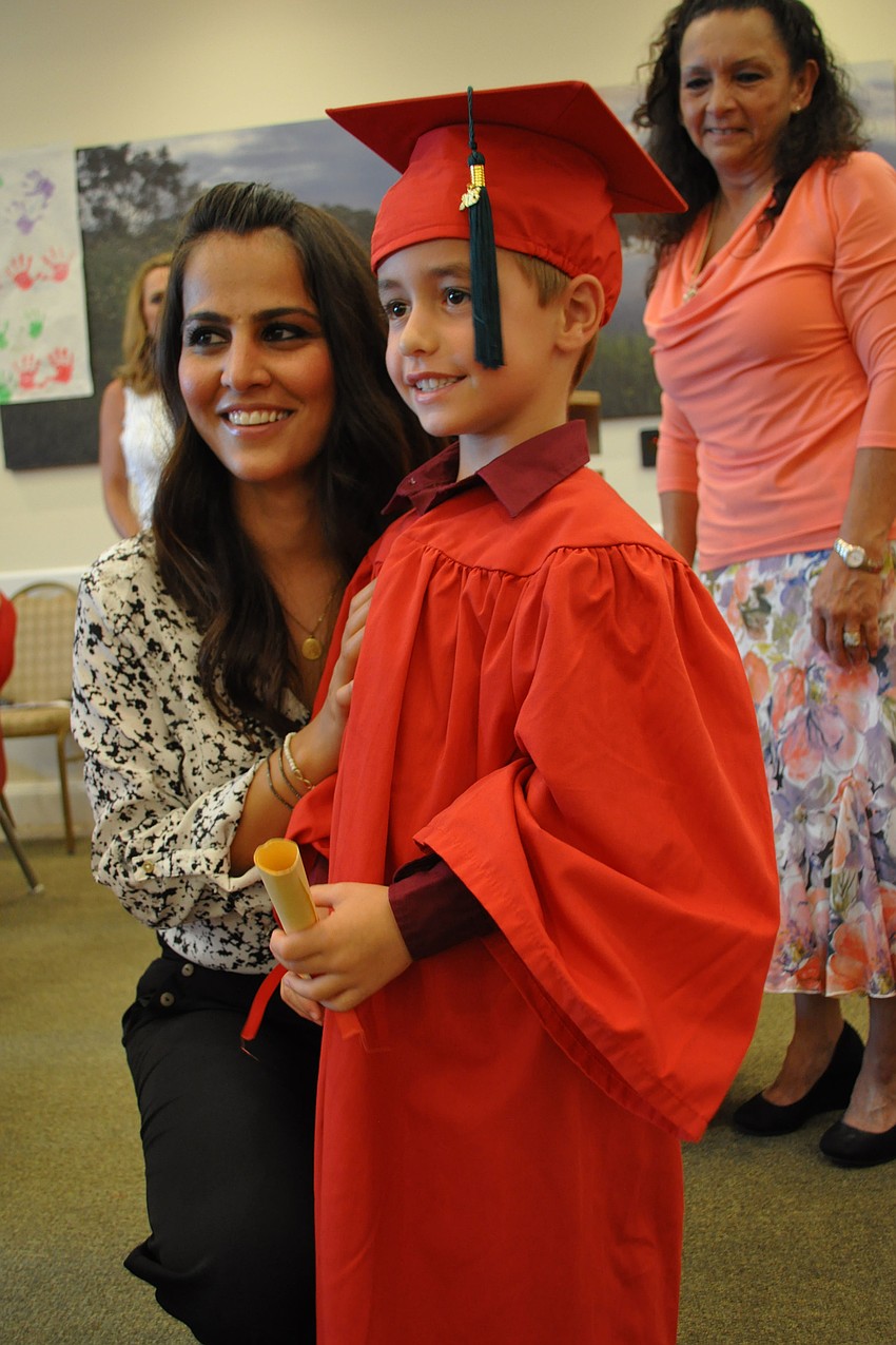 Teacher Shagolfa Hassanzadeh poses with Parker McElyea.