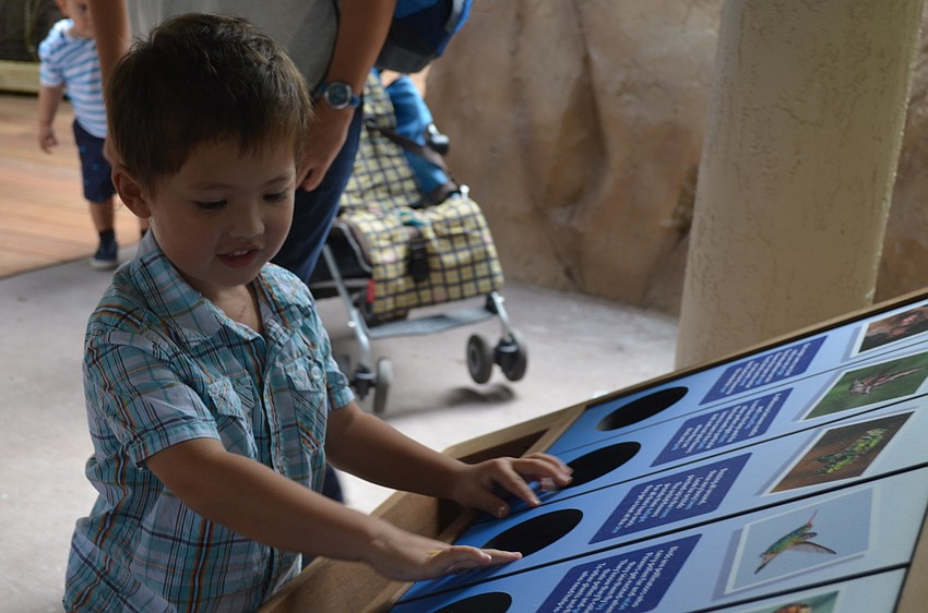 Griffin Roberts plays at one of the interactive stations