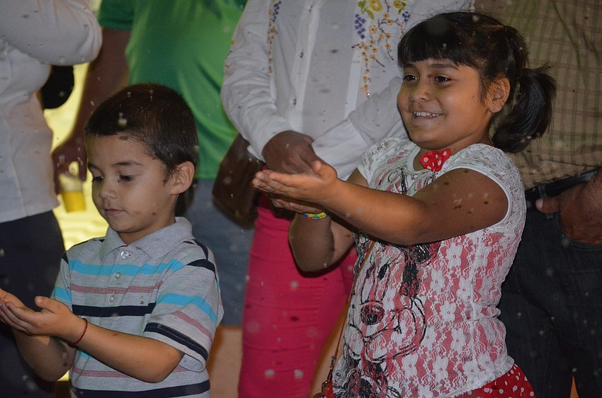 Joaquin and Ashley Ortega catch snowflakes.