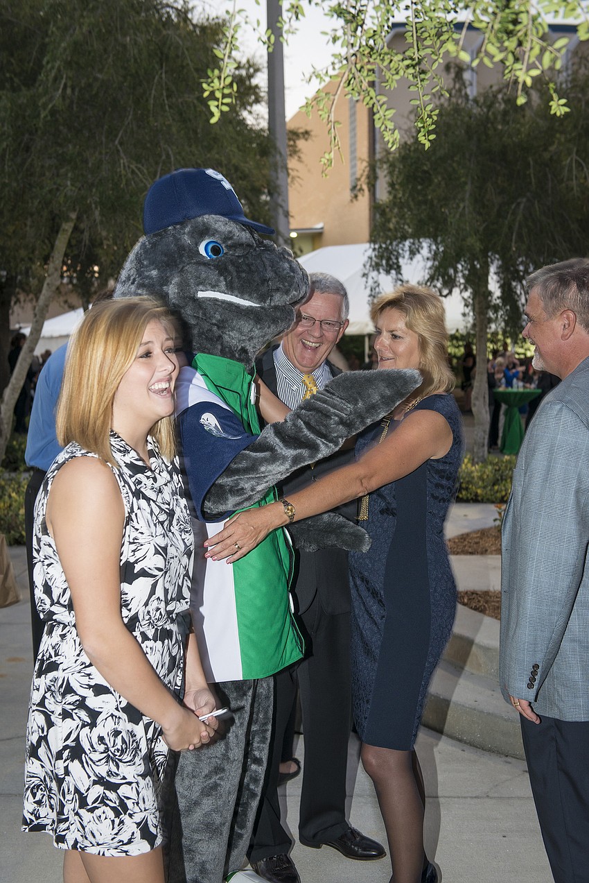 SCF President Dr. Carol F. Probstfeld and her husband, William A. Murphy, greet SCFâ€™s mascot, Maverick the Manatee, at the inauguration reception as Steve Prouty, SCF general counsel, and SCF students look on.