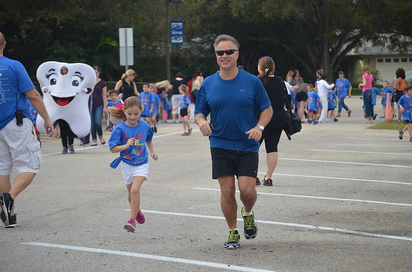 Danielle Kruk and dad, Dennis, run side-by-side.