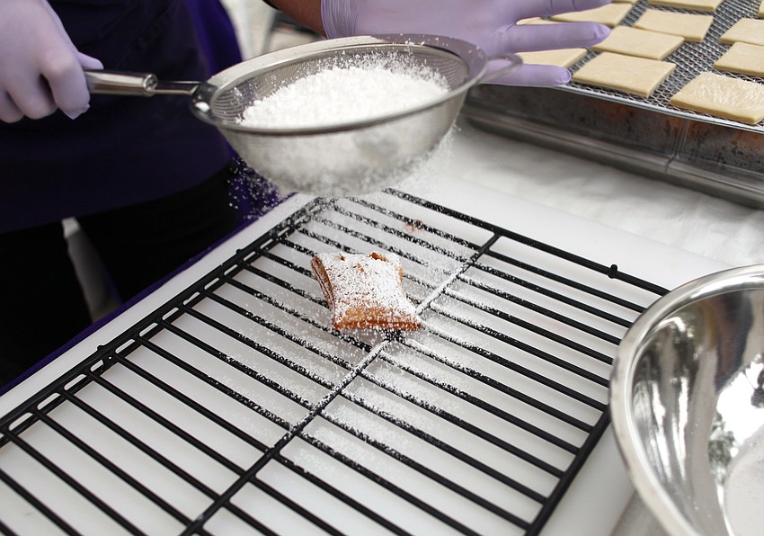 Kathy Connett of Belleâ€™s Beignets prepares sweet treats for the brunch.