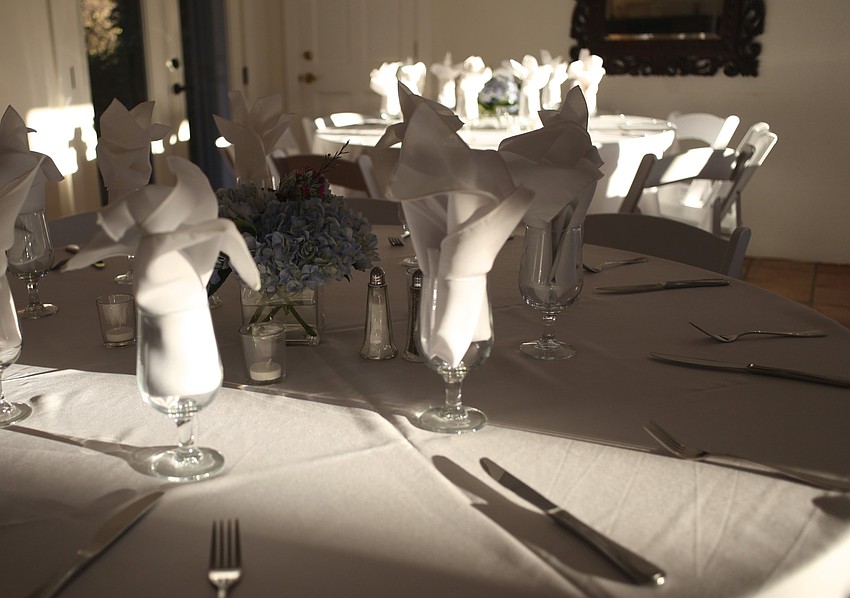 Elegant white tables were set for attendees.