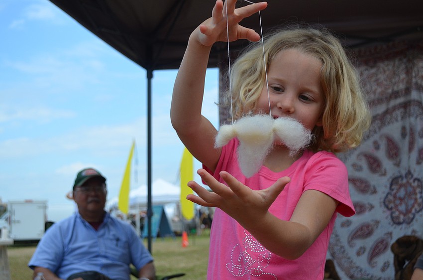 Lucy Treibly admires her hummingbird made of wool.