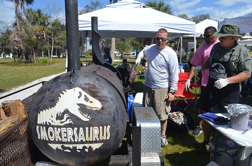 Doug Brett pulls out a rack of ribs from St. Cedar Hammock's Smokersaurus.