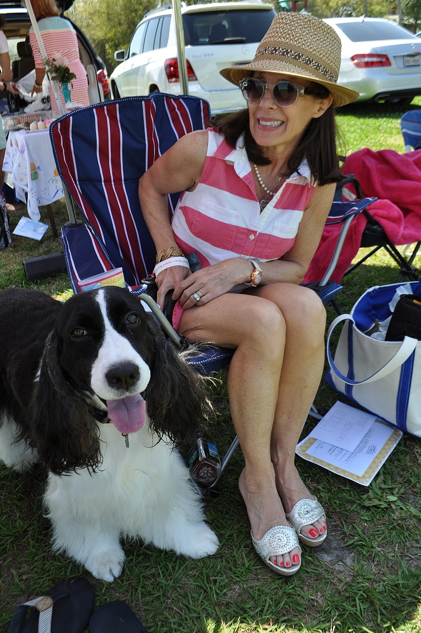Laura Andrews pets her dog, Kirby.