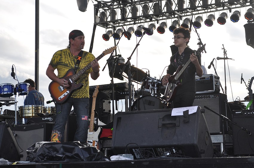 Special guest Jake Castro (right), an 11-year-old guitar prodigy, performs with his band.