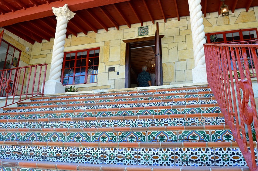 Tiled stairs lead to the front door.