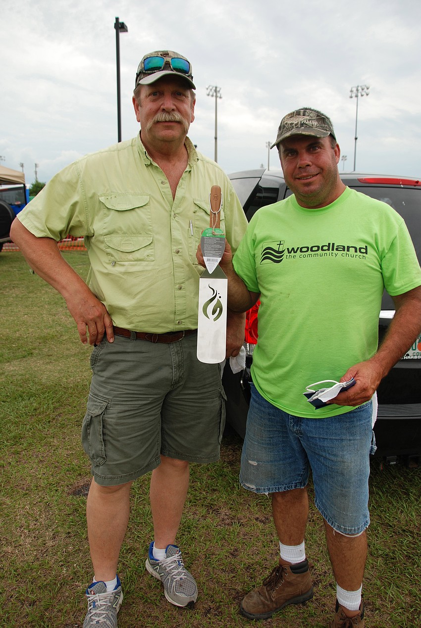Wayne Wingard and Cason Britt pose for a picture after winning third place and a spatula in the Hamburger Cook-Off.