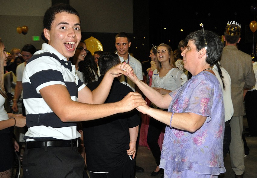 Lorenzo Tabores and Allison Belzinsky have fun dancing with one another at the prom.