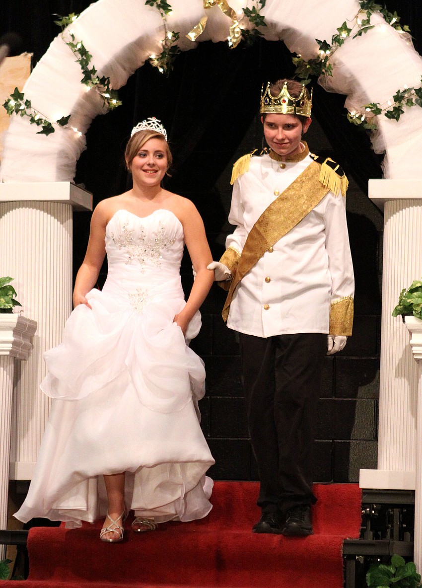 Cinderella, Paige Merriman, and Prince, Kyler Inman, come down the stairs dressed for their wedding.