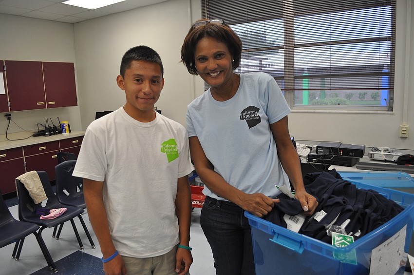 Kevin Zeas and Sandy Marchese handed out t-shirts at Bashaw Elementary School.