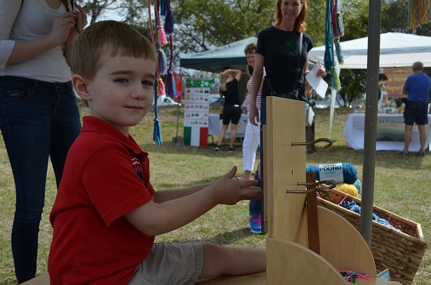 Noah Wilson plays with rope winder used for making jump ropes.