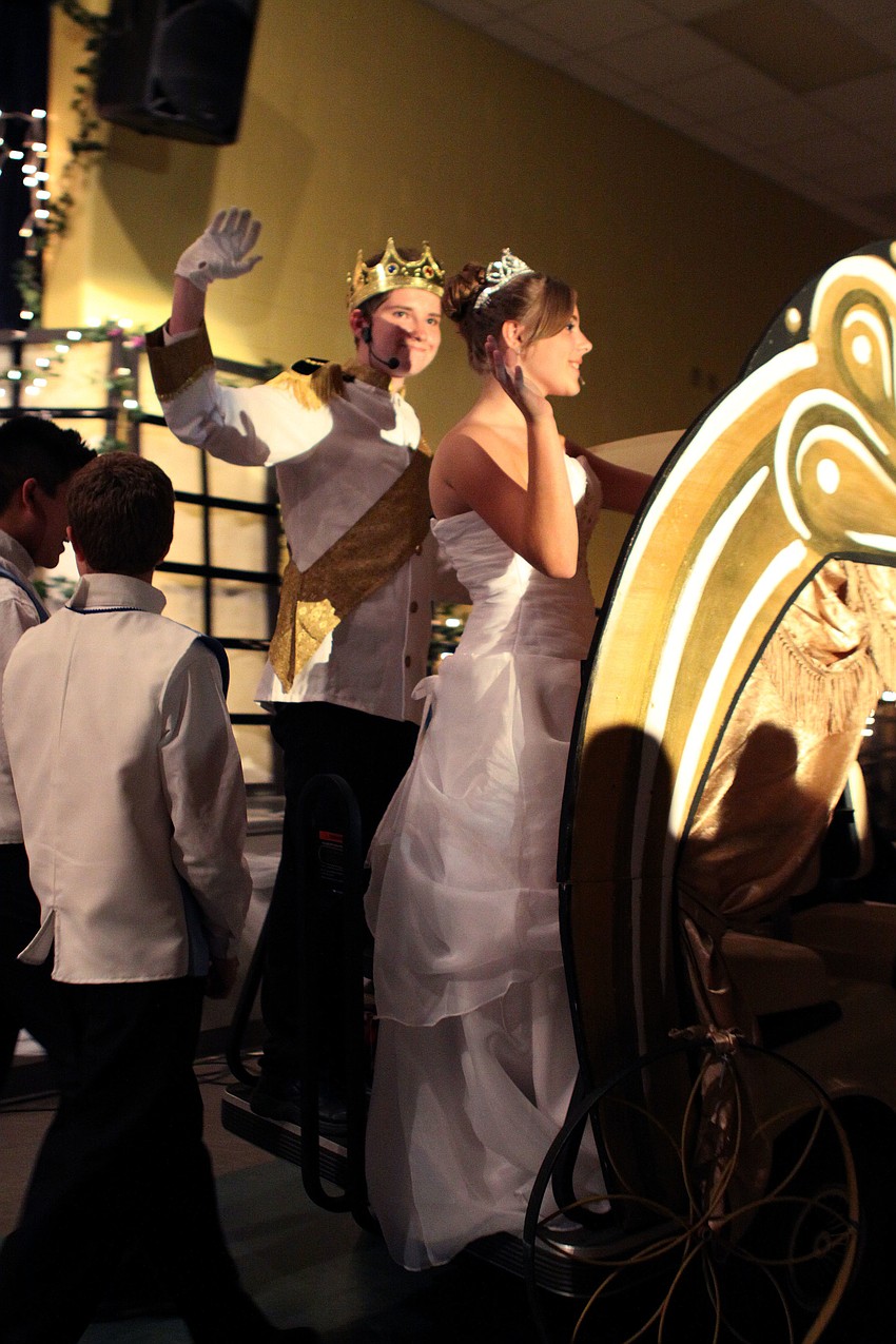 Prince, Kyler Inman, and Cinderella, Paige Merriman, wave as they ride away on their carriage.