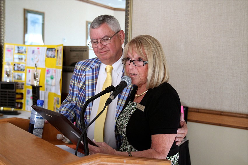 Bill Carman received a plaque from Executive Director Diana Corrigan for his dedication to the association.