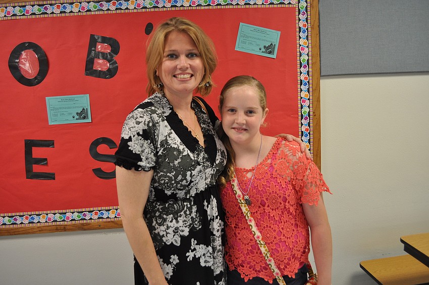 Sarah Mckinney with Jaye Kendzior, a fifth grader at Bashaw Elementary School who wants to make her cursive better