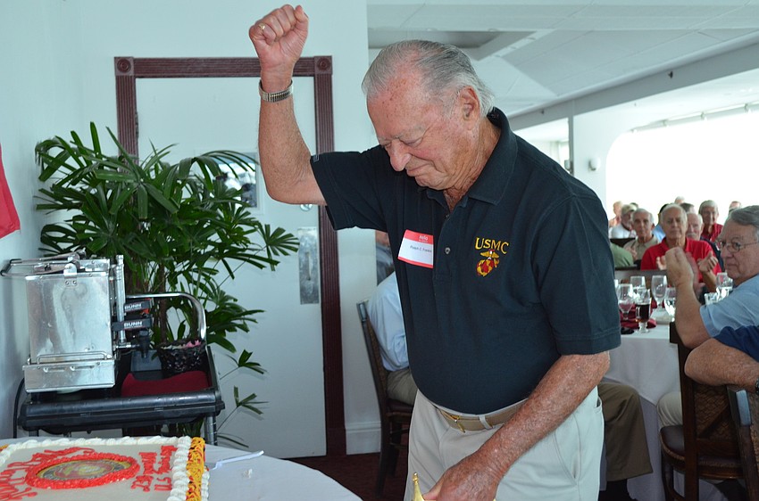 As oldest Marine at the luncheon, Ralph Franklin also cuts the cake.
