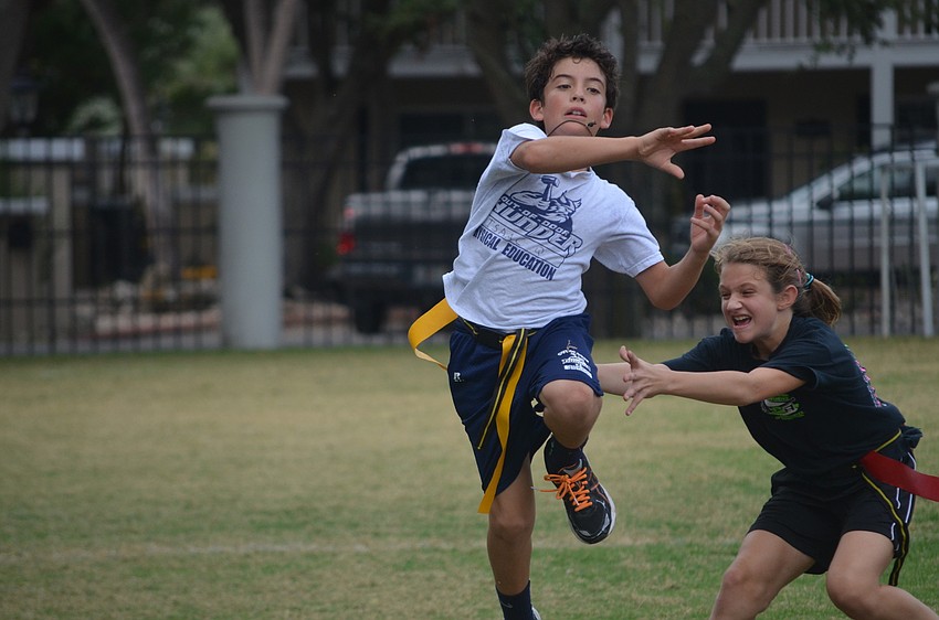 Heather S. goes for Quinn I. as he throws the ball