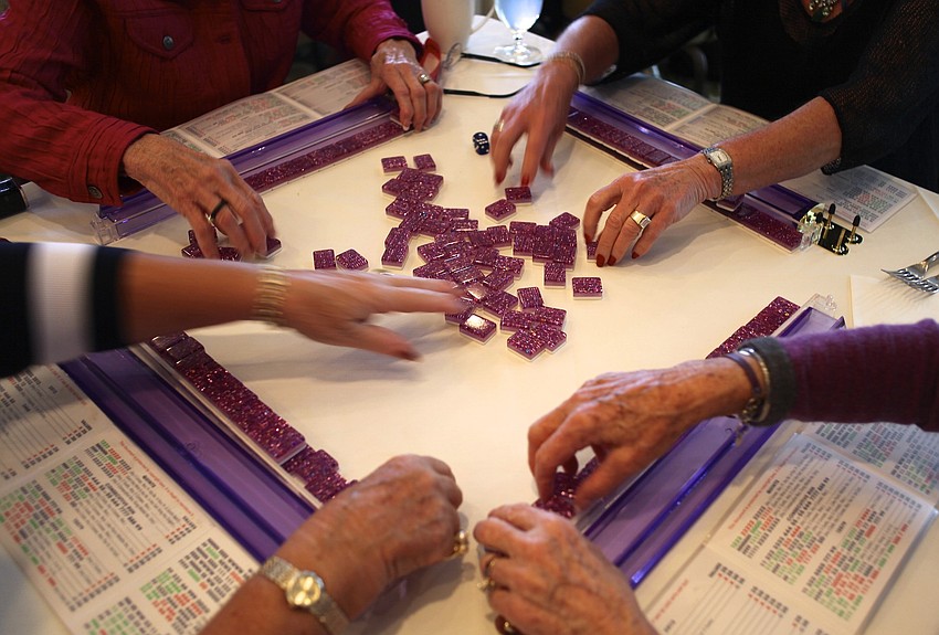 Margaret Lachmann, Carol Westwood, Jan VanIten and Barb Kiefer enjoy a game of mahjong.