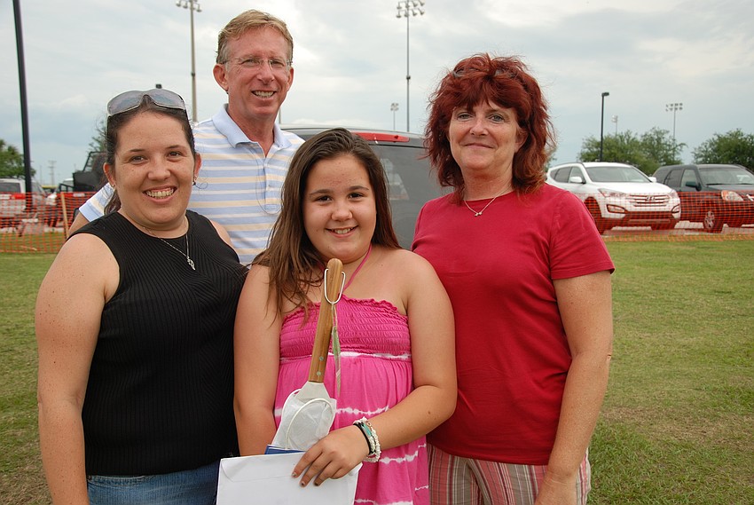 Jennifer and Alexis Fretz, Lisa Johnson and Greg Hayes gather together after winning first place in the Hamburger Cook-off, as well as a one-month YMCA membership.