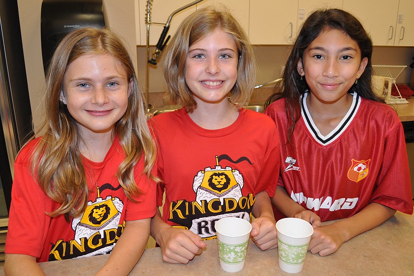 Hannah Swartz, Bella Bush and Nina Dinh prepare snacks for VBS children.