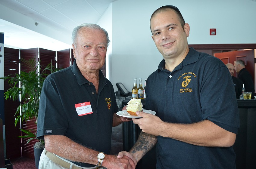 Ralph Franklin served youngest Marine at the luncheon, Jason Mikolajcik, a piece of cake.