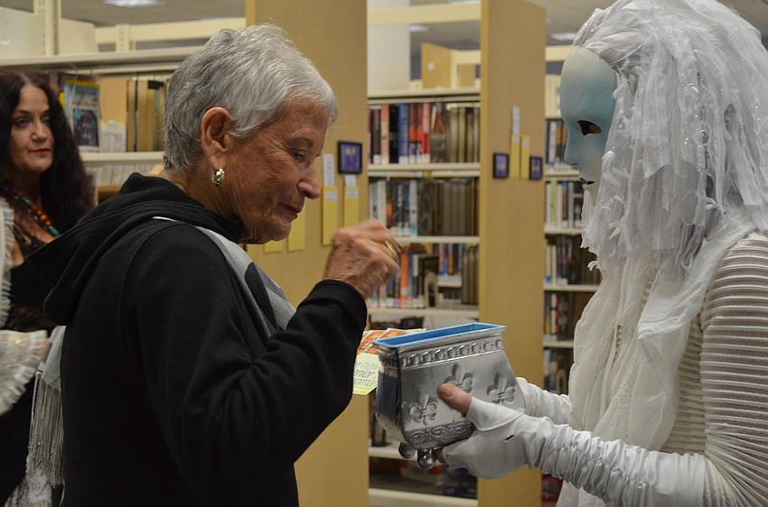 Marylen Oberman picks out a dream from Scylla Liscombe's box of dreams.