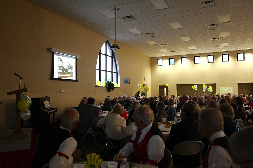 Attendees watch a video montage dedicated to the Rev. Bruce Porter.