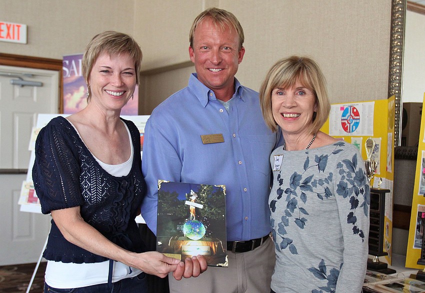 President Eric Seace poses with Christy Perry and Sandy Taylor of Destination Florida.  They were one of the 1st place winners for the â€œFright Nightâ€ statue-decorating contest.