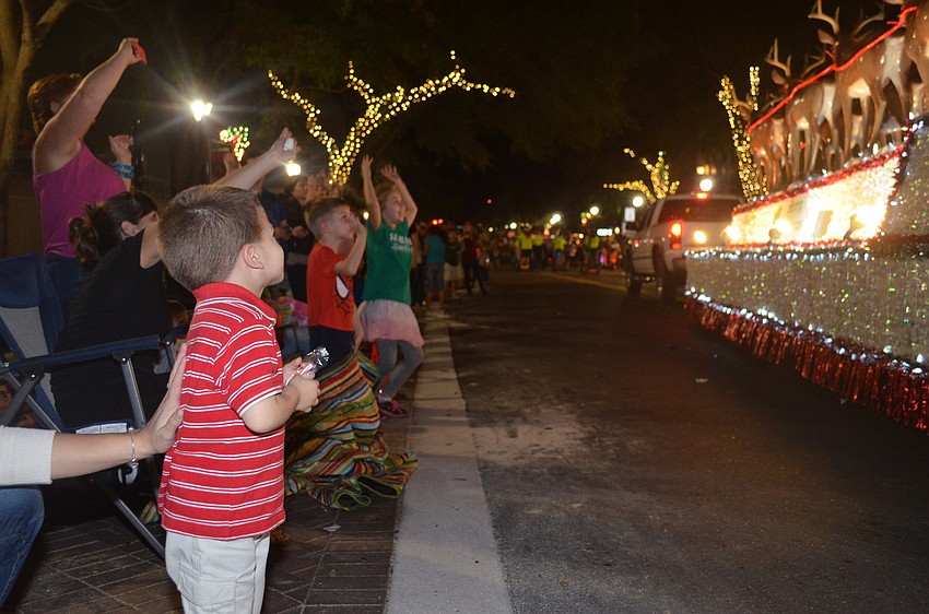Cameron Lovell looks on as Santa makes his way down Main Street