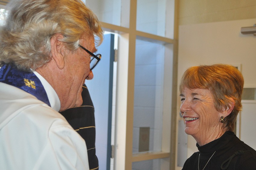 The Rev. Dr. Vince Carroll greets Peggy Sloan