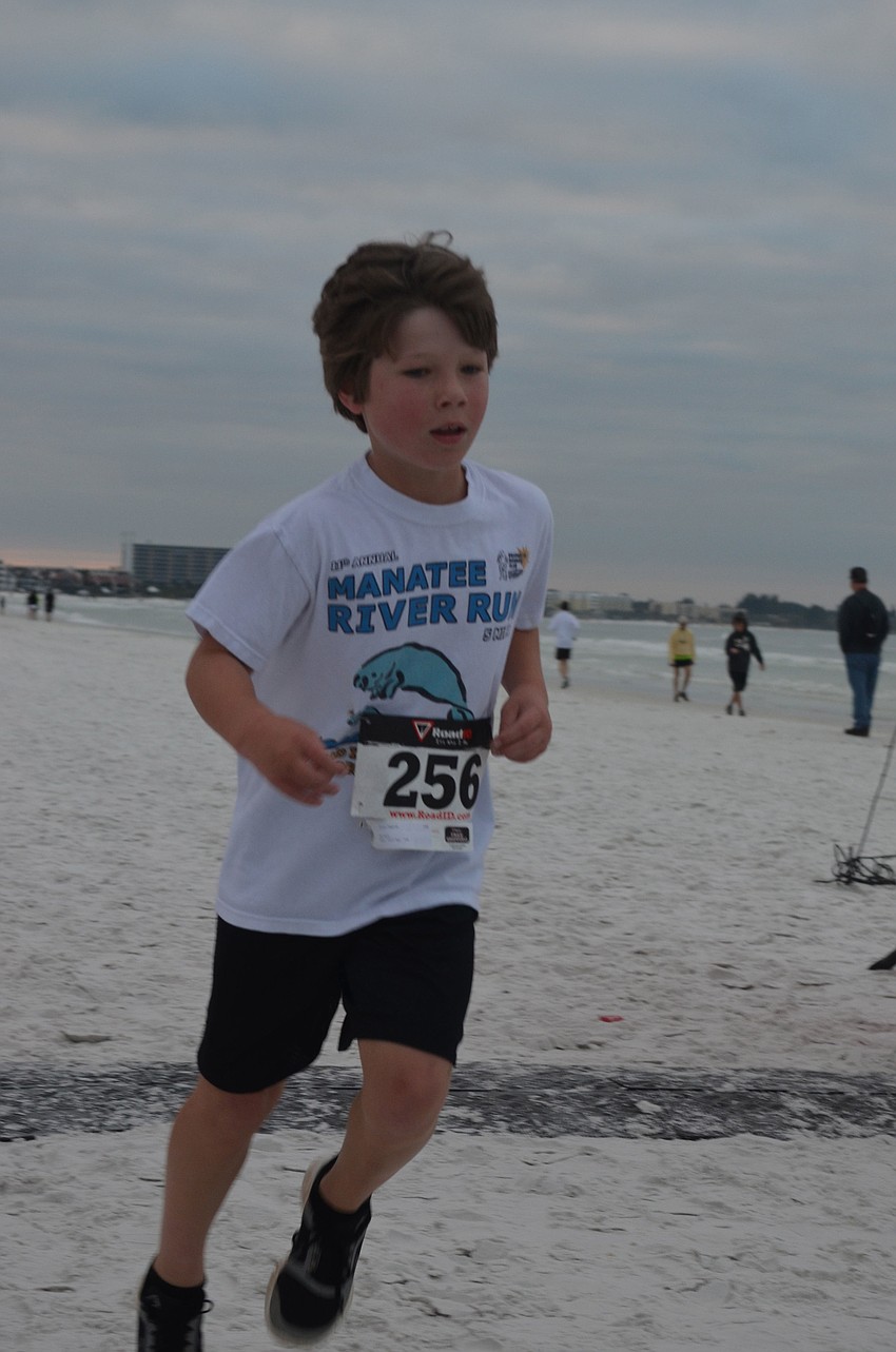 Finn Harris finishes the 1 â€“ mile â€“ fun â€“ run/walk.
