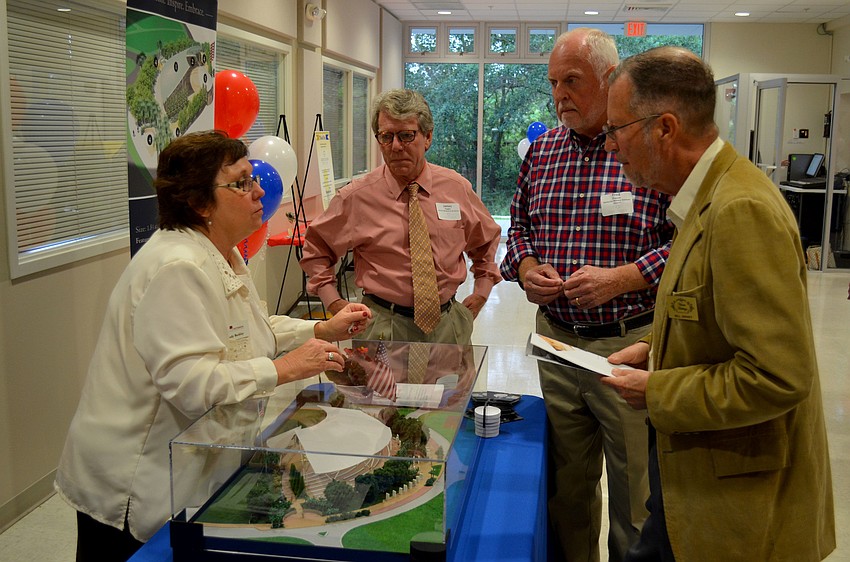 Sandy Beckly shows a model of Patriot Plaza.