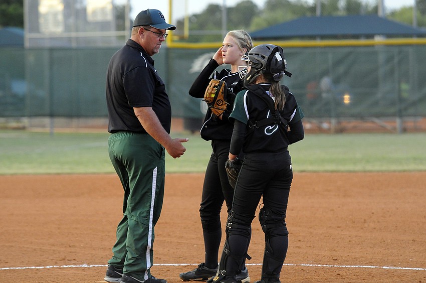 Lakewood Ranch coach Tony Cummins talks strategy with pitcher Amanda Rak and catcher Maddie Biggs.