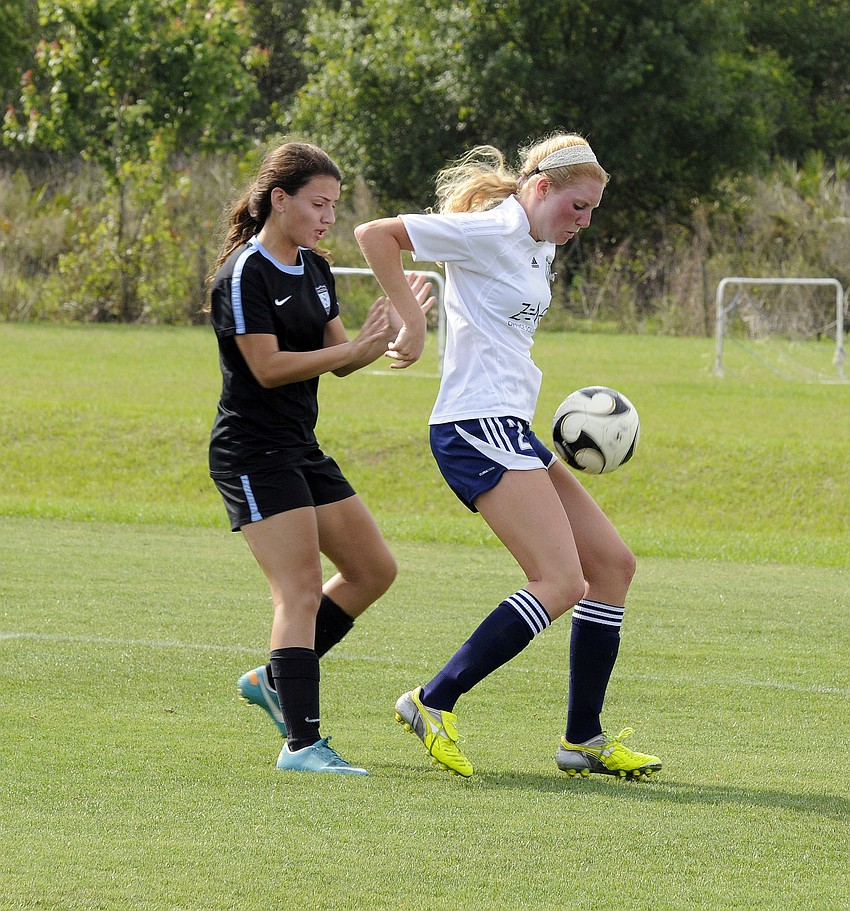 Lakewood Ranch Highâ€™s Talia Falco, right, maintains possession for the VSI West Florida Flames U17 team.